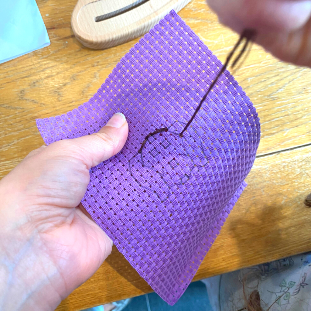 Photo of young crafter embroidering a dog